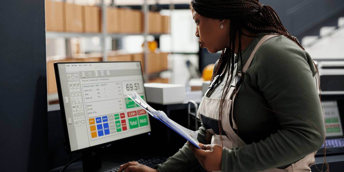 woman in a warehouse working on a computer