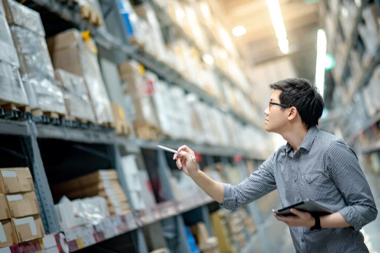 man managing inventory in a warehouse