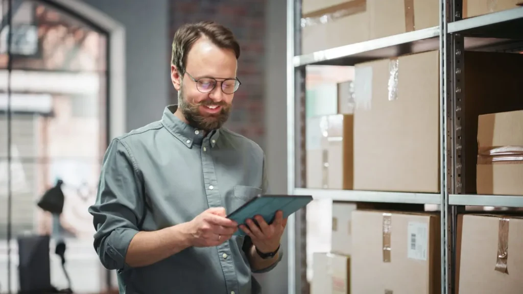 Man in warehouse managing online orders