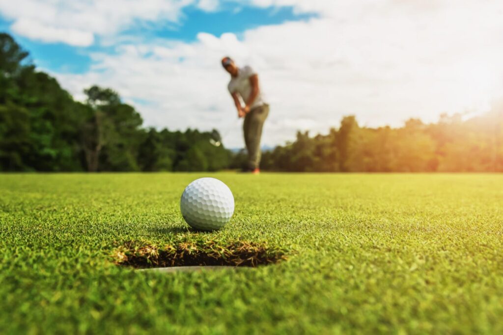 golf ball about to go into the hole