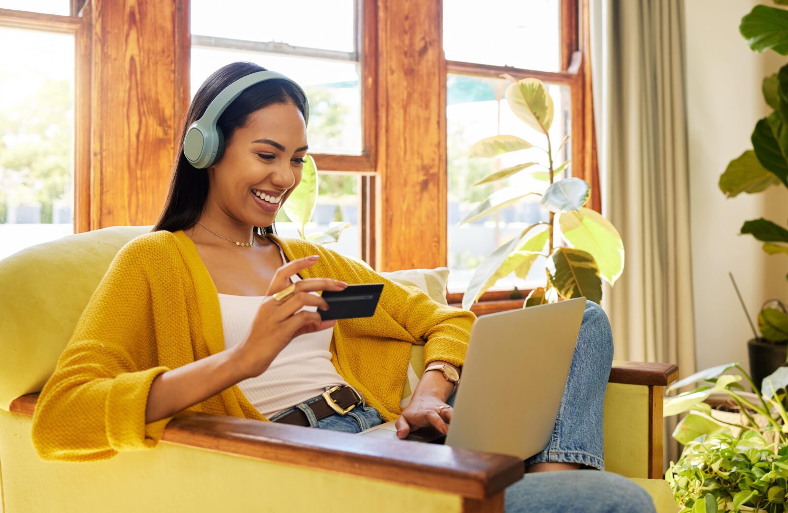 woman shopping online while sitting on her couch