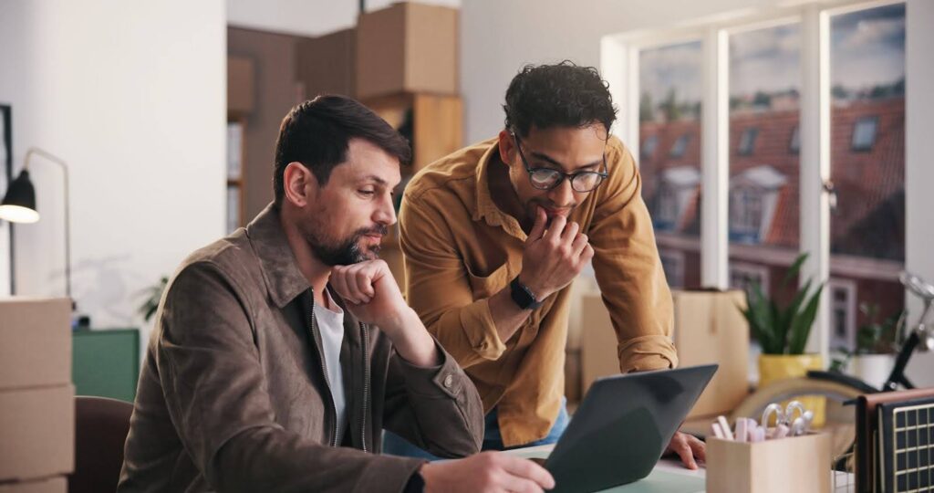 Two person looking at the laptop screen